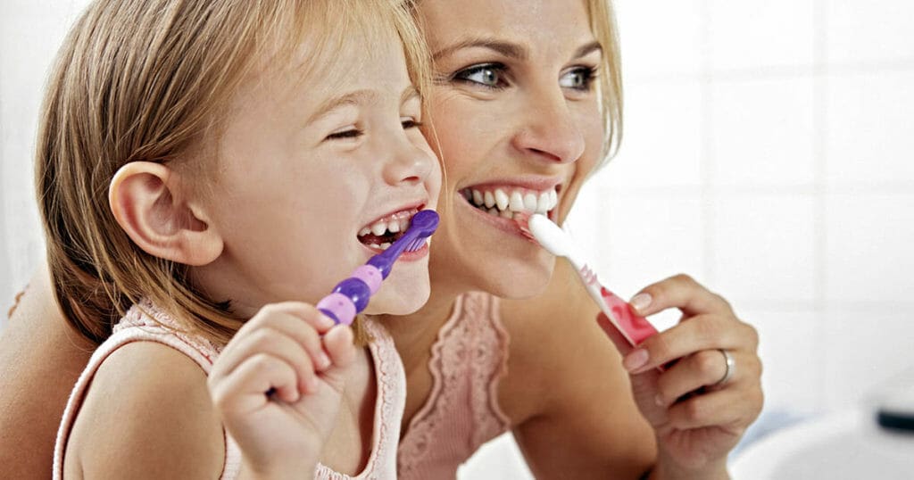 Mother And Daughter Brushing Teeth Together ICTeeth Pediatric Dentistry